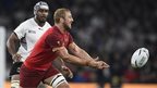 England's flanker and captain Chris Robshaw passes the ball during the opening game of the Rugby World Cup against Fiji