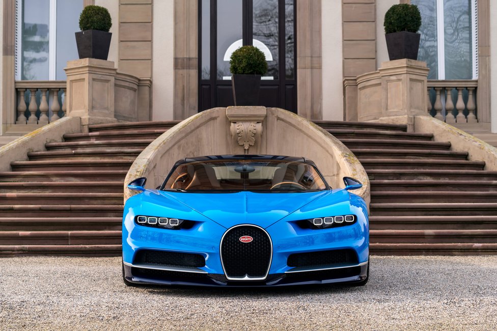 Chiron parked in front of country house