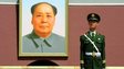 A paramilitary policeman stands guard in front of a portrait of the late chairman Mao Zedong in Beijing's Tiananmen Square