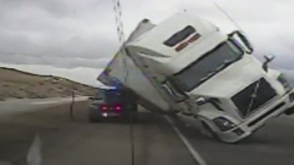 Strong winds in US topple truck on highway