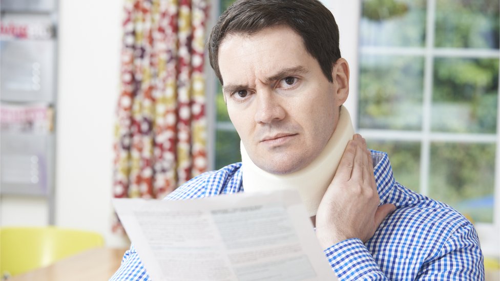 Man with neck injury reading letter
