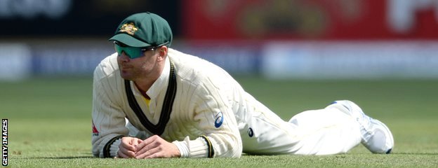 Michael Clarke reacts after dropping Ian Bell