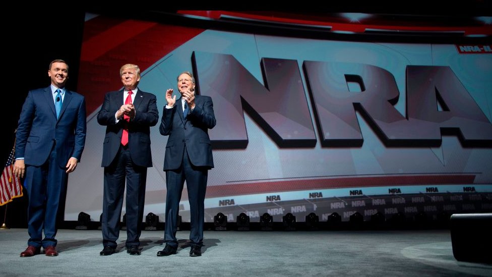 US President Donald Trump stands with National Rifle Association (NRA) President Wayne LaPierre (R) and NRA-ILA Executive Director Chris Cox (L) during the NRA Leadership Forum in Atlanta, Georgia on April 28, 2017.