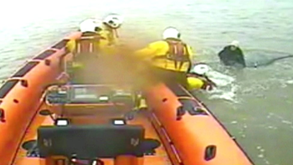 Woman rescued from roof of submerged car on Cumbria beach