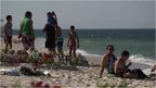 Memorial and tourists on Tunisian beach in Sousse