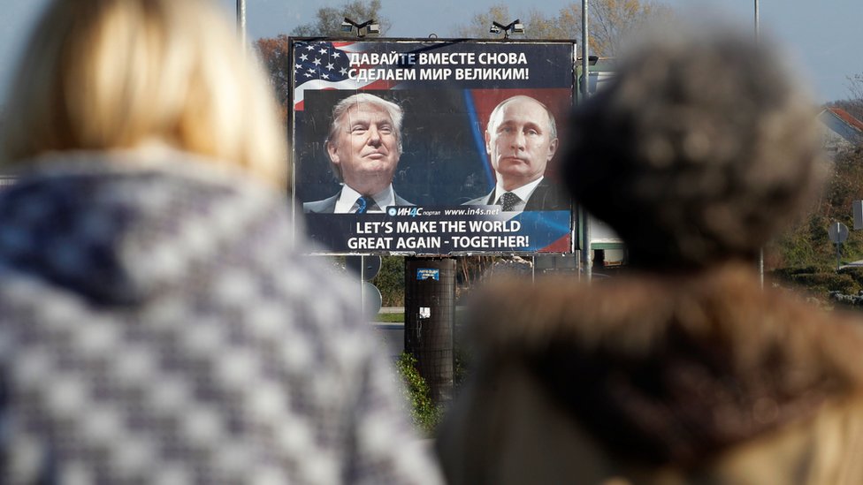 A billboard showing a pictures of US president-elect Donald Trump and Russian President Vladimir Putin is seen through pedestrians in Danilovgrad, Montenegro, 16 November 2016.