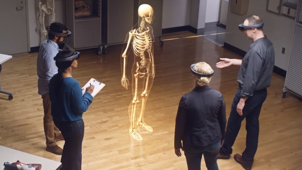 Students wearing headsets and looking at a virtual skeleton
