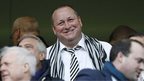 Mike Ashley wears a Newcastle scarf at a club game