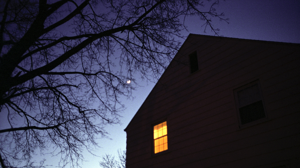 Single lighted window at night