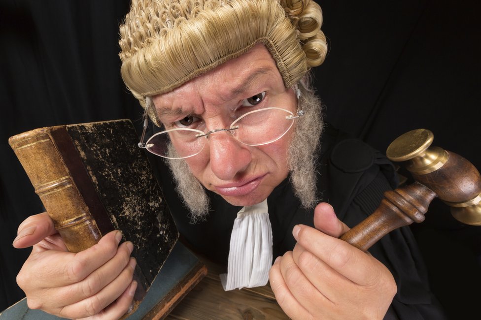 Judge with book and gavel