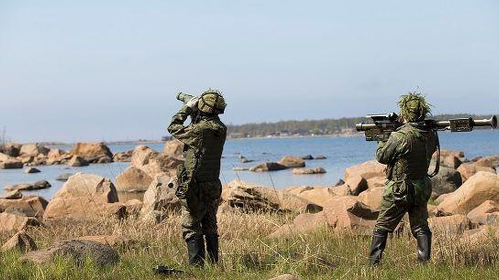 A press release photo of soldiers on a training exercise by the sea