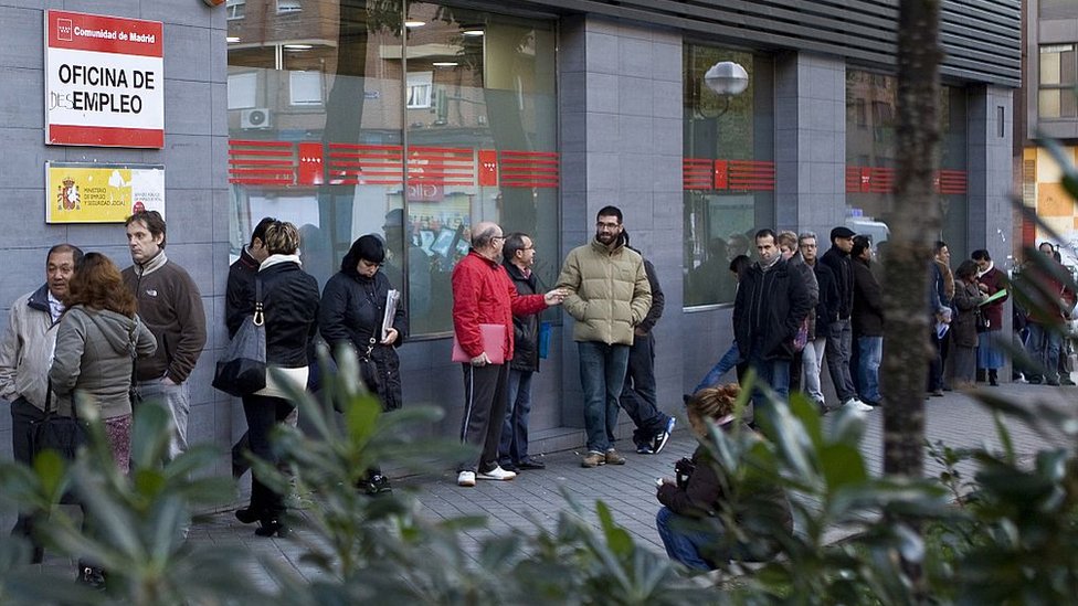 Gente en la puerta de una oficina de empleo