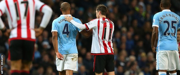 Vincent Kompany is consoled by Sunderland's Adam Johnson