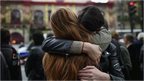 Parisians hug each other in support over the Paris attacks