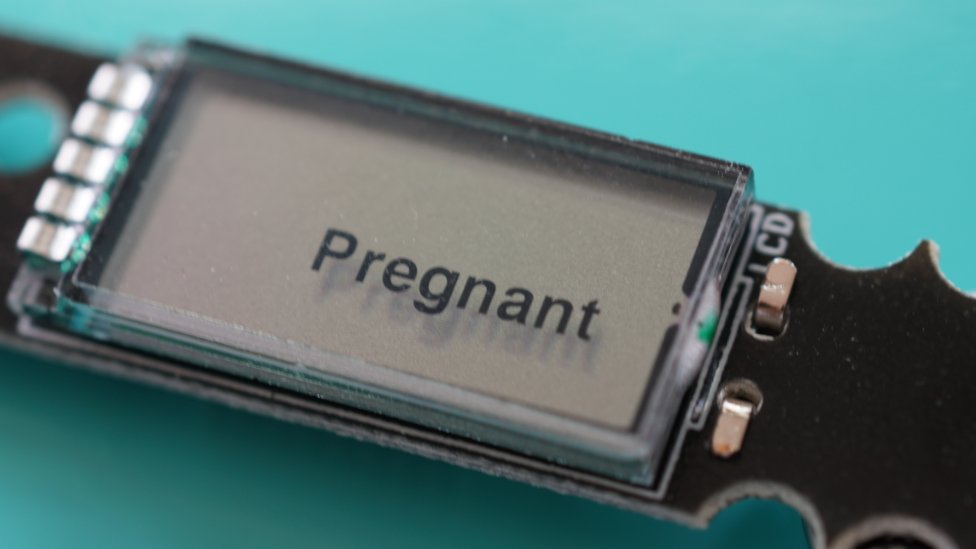 A liquid crystal display that says pregnant