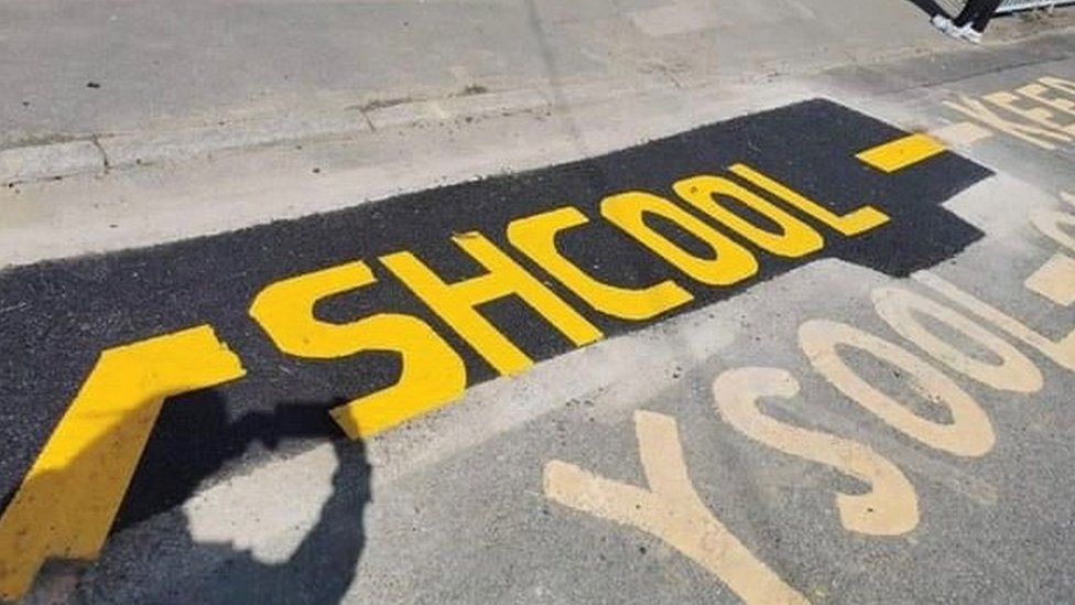 Workers misspell school when repainting road