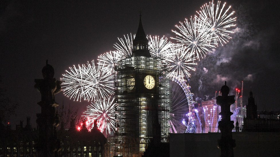 Elizabeth Tower, the building colloquially known as "Big Ben" for the bell in its clock tower, is silhouetted against the fireworks of London