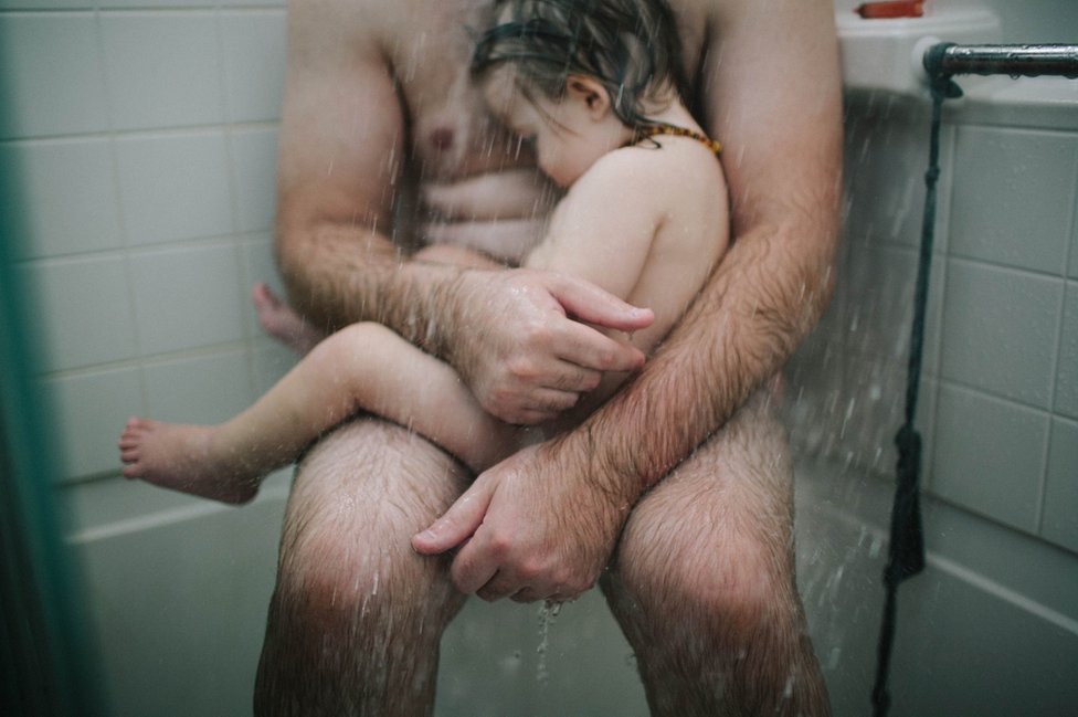 Thomas in the shower with his son Fox