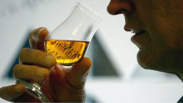 man tasting whisky