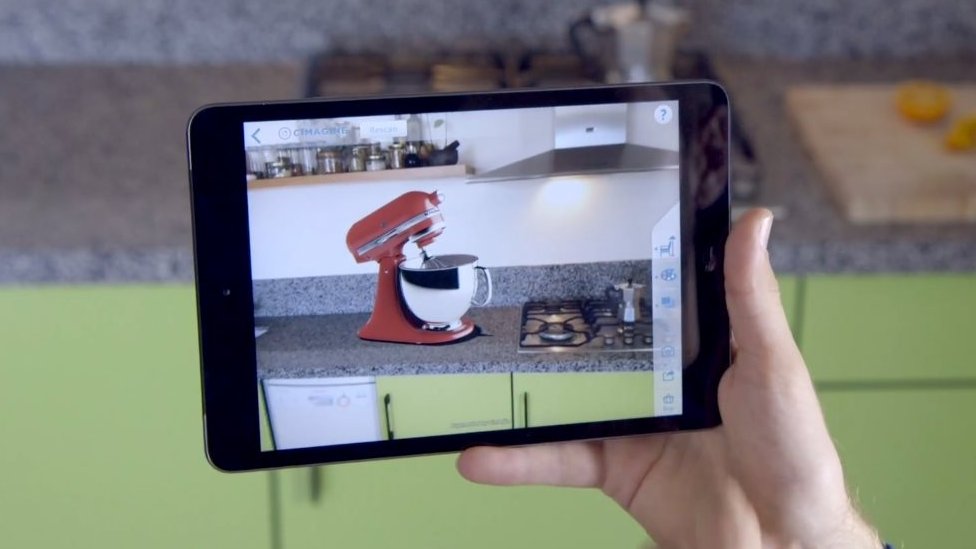 Tablet video camera showing food mixer superimposed on kitchen worktop