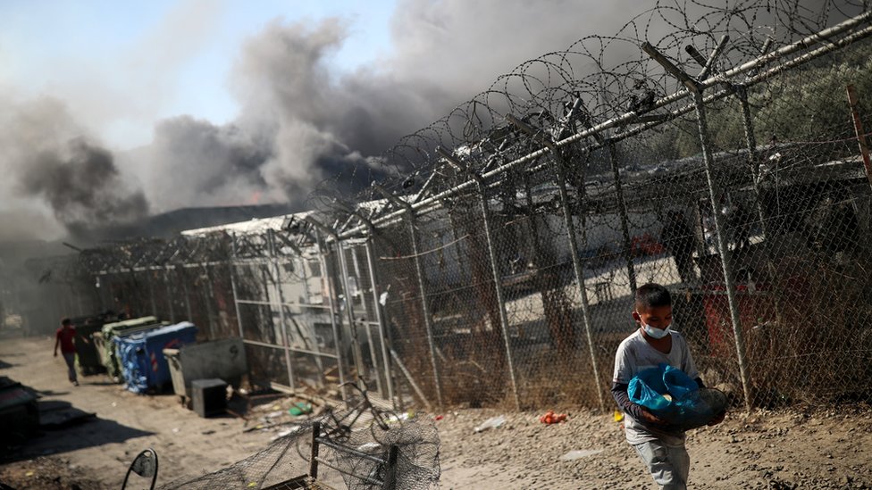 A child walks among destroyed shelters following a fire at the Moria camp for refugees and migrants on the Island of Lesbos, Greece 9 September 2020