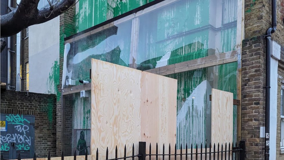 Banksy: London tree mural covered in plastic and boards