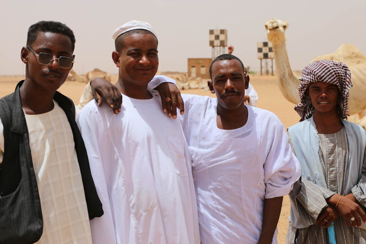 Vendors and a rogue interloper at the camel market near Khartoum