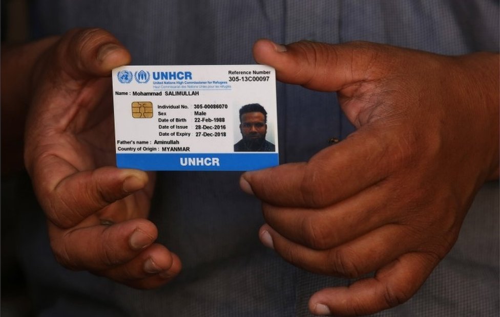 A Rohingya Muslim man Mohammad Salimullah (Unseen), showing his ID card given by United Nations High Commissioner for Refugees (UNHCR) to protect them from any arbitrary detention in a makeshift settlement in Madanpur Khadar, in New Delhi, India, 22 August 2017,