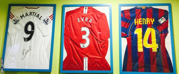 Shirts from Martial, Evra and Henry hanging on the wall at Les Ulis