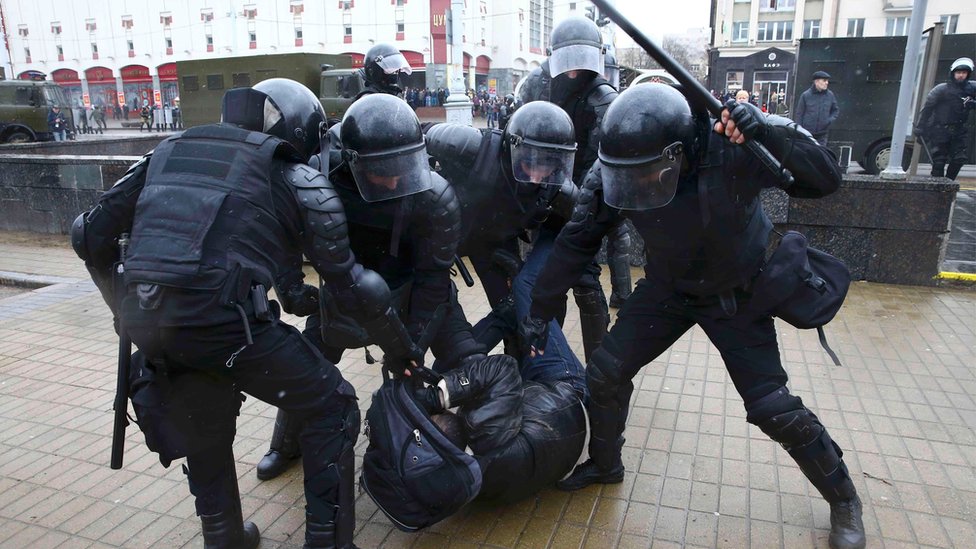 riot police arrest a man