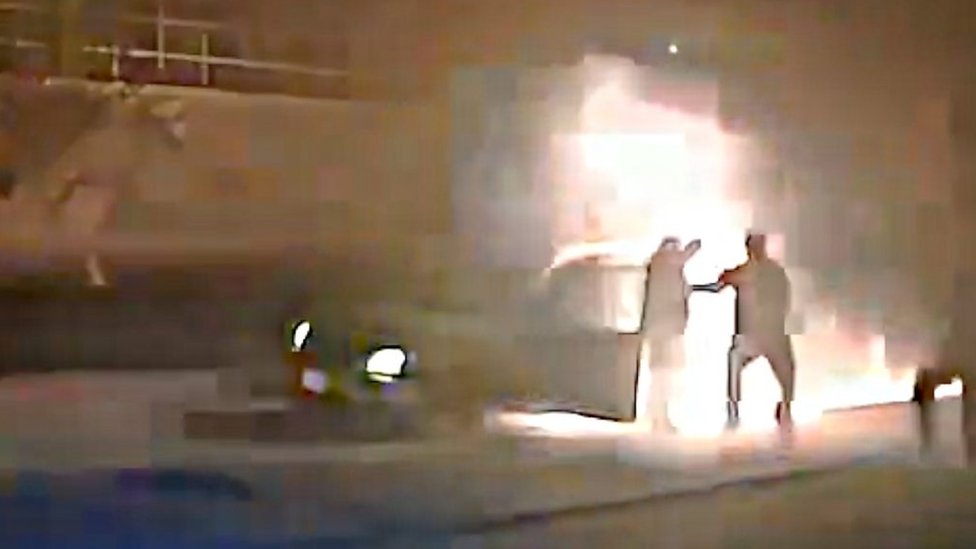 Watch police pull man, 84, away from blazing car