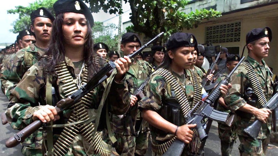 Far rebels parade in the Colombian town of San Vicente in 2001.
