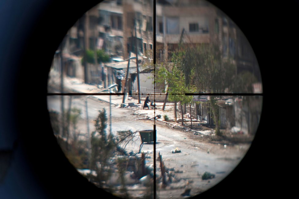 A mother and baby seen through a sniper's sights
