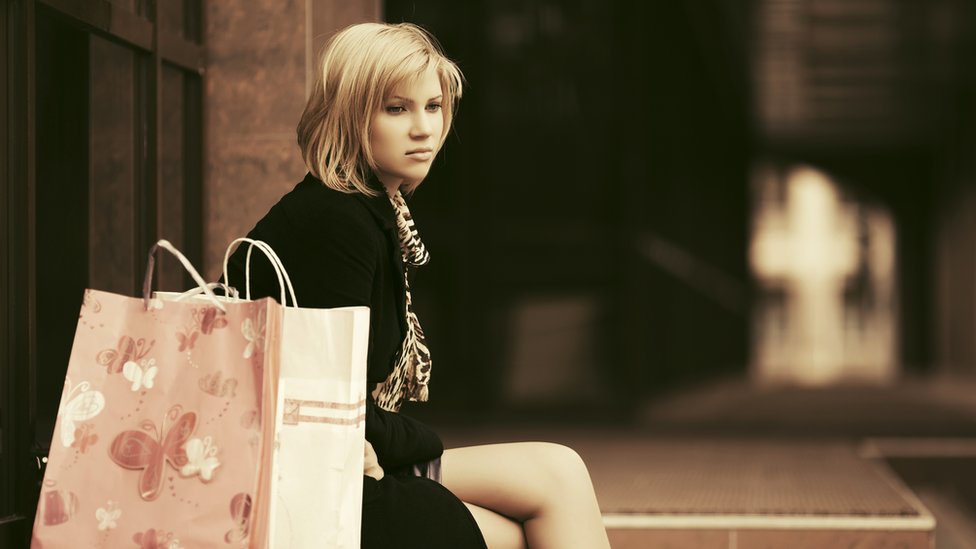 Woman looking sad with her shopping