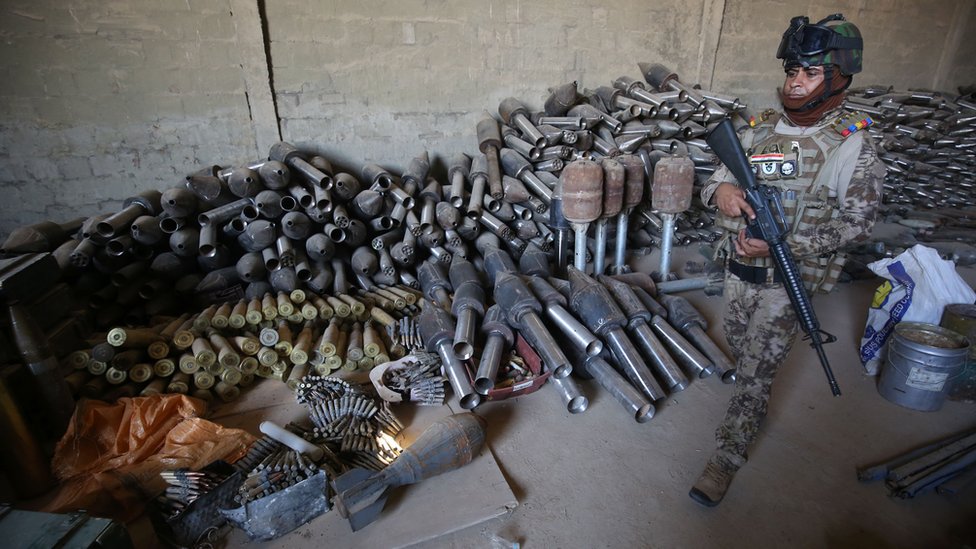 Iraqi soldier near weapons collected after IS was defeated in Falluja (file photo)