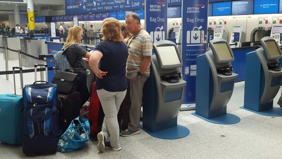 Passengers at the British Airways check-in desk at Gatwick Airport on 27 May.