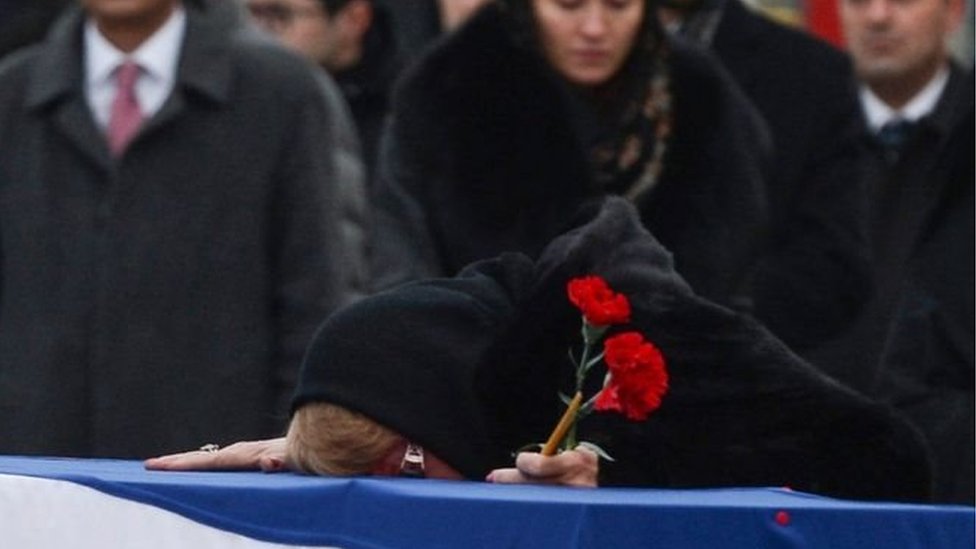 زوجة السفير الروسي كارديف الذي اغتيل في تركيا تبكيه قبل نقله لدفنه في روسيا
