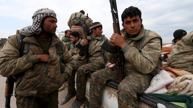 YPG fighters carry their weapons on a pick-up truck in Qamishli, Syria (11 March 2016)