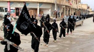 This undated file image posted on a militant website on Tuesday, Jan. 14, 2014 shows fighters from the al-Qaida linked Islamic State of Iraq and the Levant (ISIL) marching in Raqqa, Syria. 