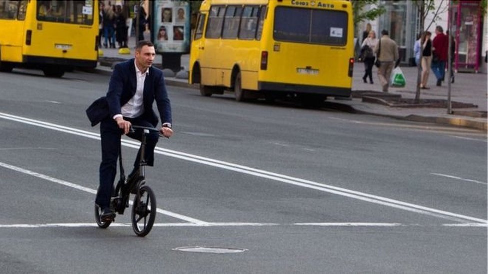 Vitaliy Klitschko's riding a bike.