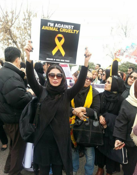 A woman holding up a placard