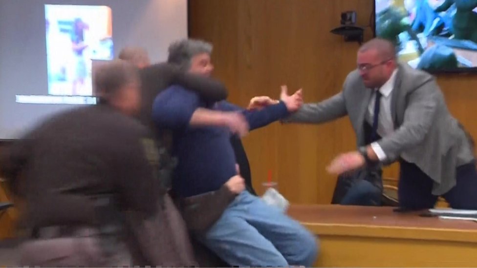 Victim's dad lunges at disgraced Olympic doctor