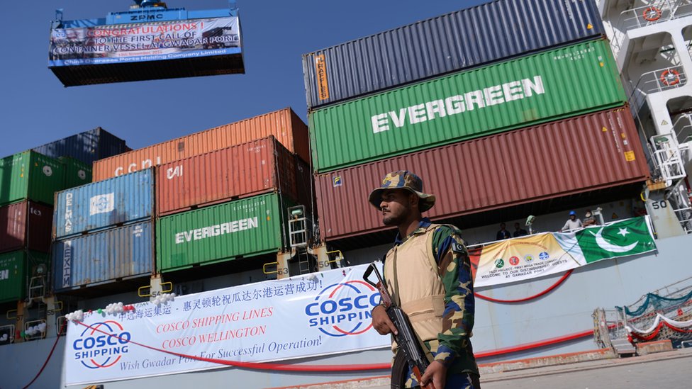 A Pakistani Naval personnel stands guard beside a ship carrying containers during the opening of a trade project in Gwadar port, some 700 kms west of Karachi on November 13, 2016
