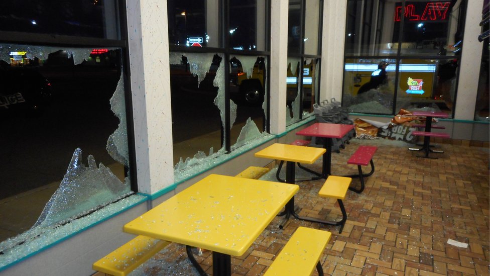 A fast food restaurant with smashed windows