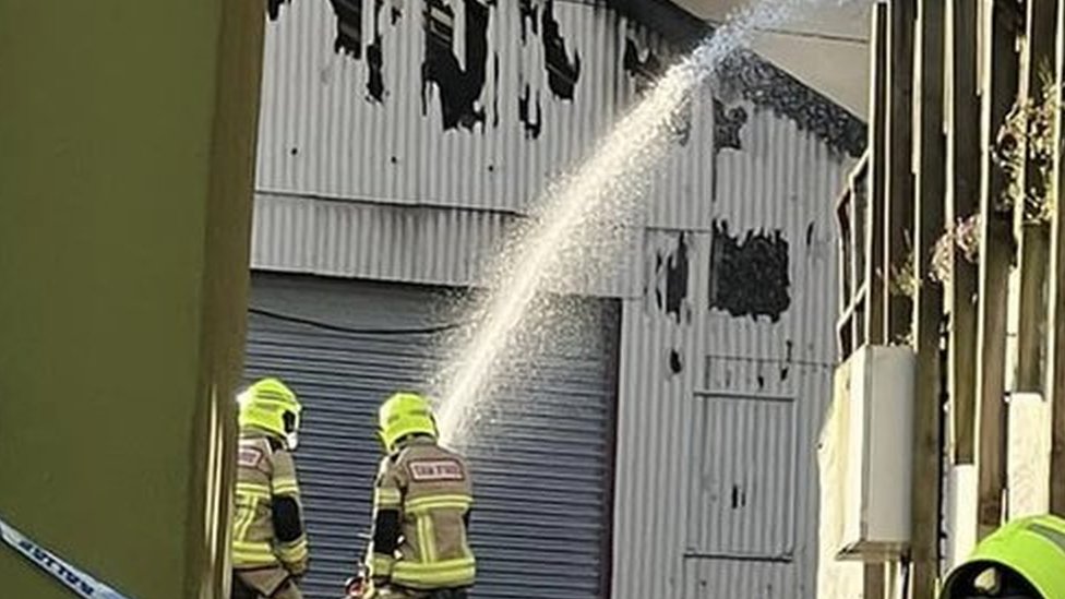 Explosions as 30 firefighters battle garage blaze