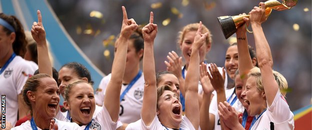 Megan Rapinoe lifts the trophy