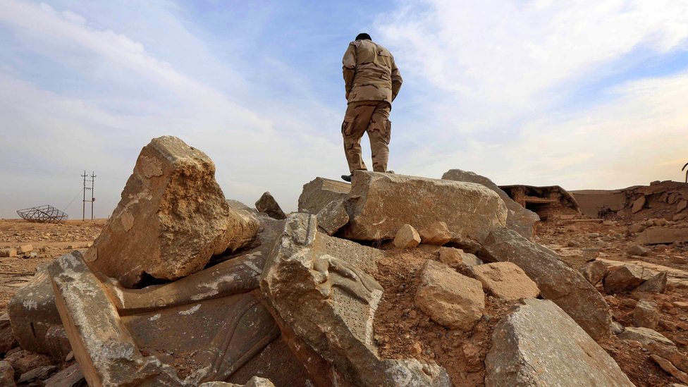 An Iraqi soldier stands on ruins of the archaeological site of Nimrud