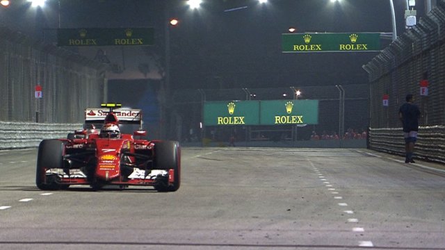 Sebastian Vettel passes a spectator on the track during the Singapore Grand Prix