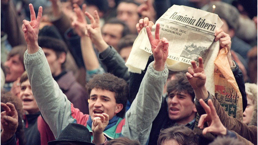 Romanians celebrate the fall of the Ceaucescu regime in December 1989