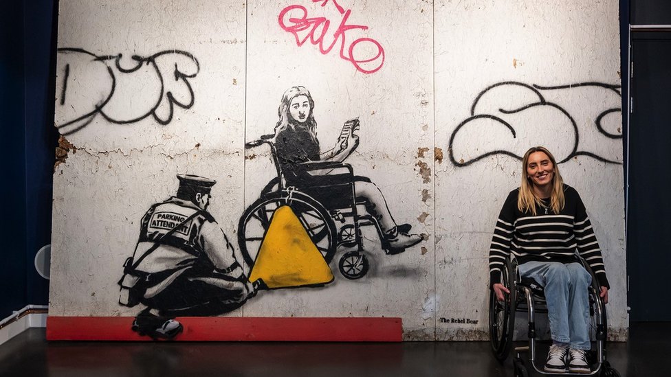 Mural shown at site of disabled parking space row